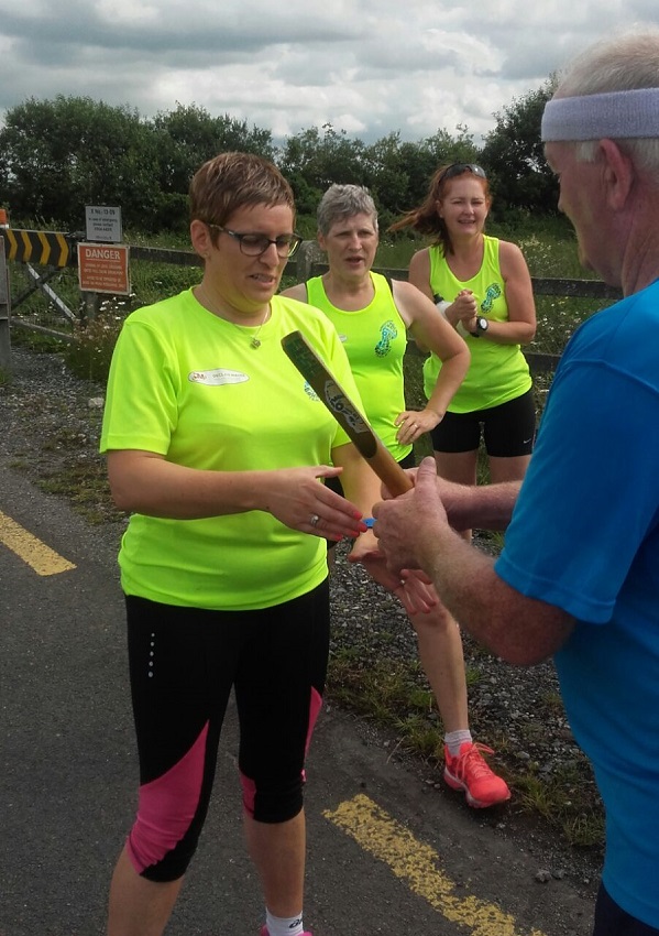 The last baton change of the Track-Attack Trip around Tipp   Paddy Kennedy handing baton to Betty Slattery. Also in photo are Teresa Murray and Mairead Lane