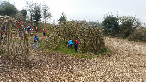 Children from Margo's Preschool enjoying the Fairy Trail and willow structures on a beautiful day in the Town Park